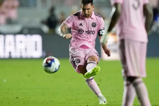 Lionel Messi kicking a soccer ball